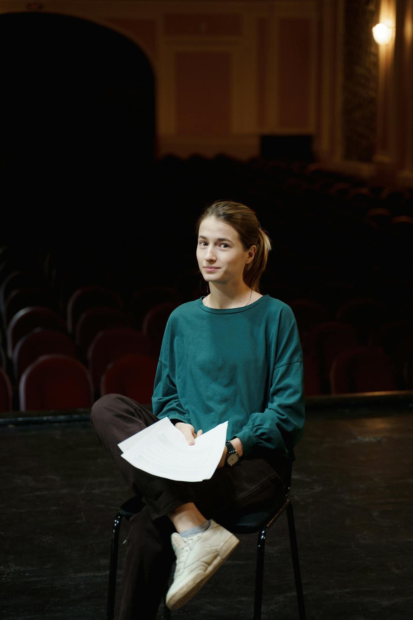 Woman Sitting On A Chair Holding A Script